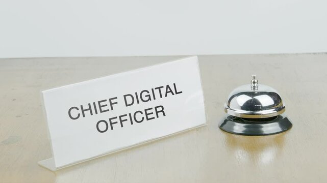 Chief Digital Officer Office or Room with Hand Ringing The Bell on Desk or Table Multiple Times