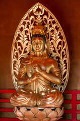 Fototapeta premium Tahoto Tower - repository of relics. Buddha figure in gold close-up. Architecture copy of building, built in Japanese Garden of Krasnodar, dates back to 1185–1333. Krasnodar Park or Galitsky Park.