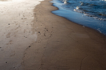 A minimalist beach scene with an empty sea and clear horizon, ideal as a background with ample copy...