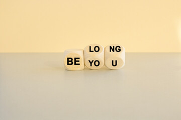 Be you, belong symbol. Turned cubes and changes words 'be you' to 'belong'. Beautiful beige...
