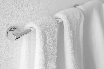 A close-up view of a towel hanging from a towel rack, great for use in bathroom or spa settings