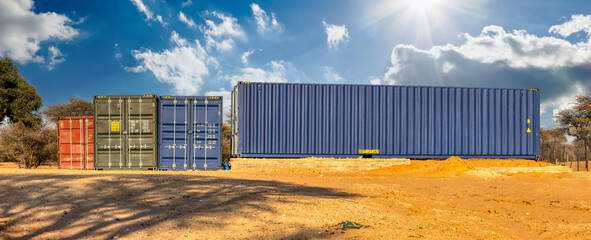 shipping containers parked on a construction site, waiting to be loaded