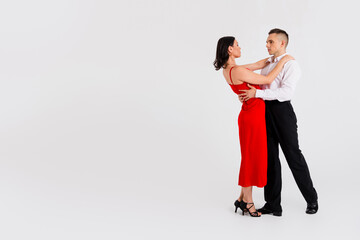 Full size profile photo of two young passionate dancing partners empty space isolated on white color background