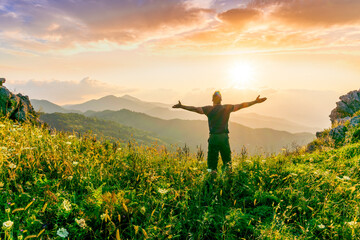 Fototapeta premium man doing hiking sport in mountains with anazing highland view