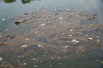 Pollution in a Water Body with Floating Debris and Plastics
