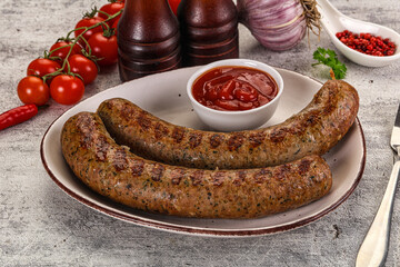 Grilled beef sausages with sauce