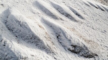 Close up of a snowy hillside with trees and rolling hills