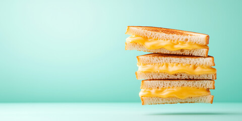Fototapeta premium A stack of three toasted sandwiches with yellow cheese in between