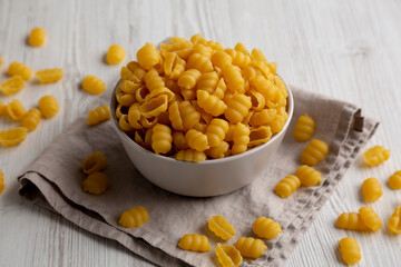 Homemade Dry Raw Gnocchi Pasta in a Bowl, side view.