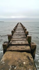 Fototapeta premium Scenic wooden pier extending into tranquil ocean under clear blue sky