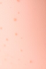 Fototapeta premium peach colored background, soft texture, subtle gradient, delicate polka dot pattern, muted tones, minimalist design, abstract composition, gentle lighting, pastel aesthetic, dreamy atmosphere