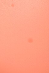 Fototapeta premium peach colored background, soft texture, subtle gradient, delicate polka dot pattern, muted tones, minimalist design, abstract composition, gentle lighting, pastel aesthetic, dreamy atmosphere
