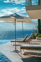 A pair of lounge chairs by the side of a swimming pool