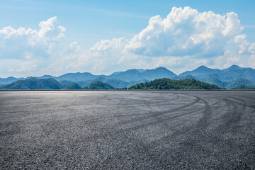 Asphalt road and green mountain with sky cloud background © ABCDstock