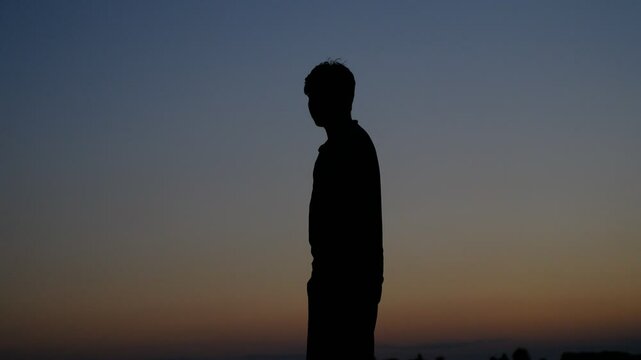 Hitchhiker man sunset silhouette