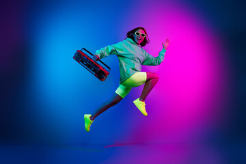 Full length photo of shiny attractive lady dressed green sweatshirt enjoying boom box songs jumping...