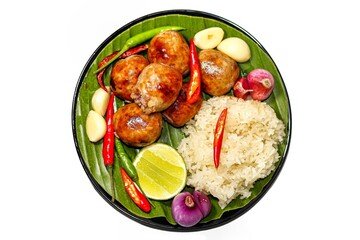 Delicious and Tasty with food Thailand with menu fried sausage with sticky rice served on banana leaves with chili onions and lemon slices put on white background in isolated concept,top 