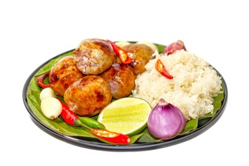 Ready for eat food Thailand with menu fried sausage with sticky rice served on banana leaves with chili onions and lemon slices put on white background in isolated concept.
