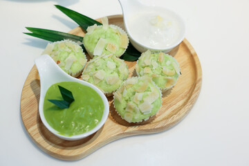 kue mangkok or kue apem or steamed rice cake that look like cup cake and usually sold in a small paper cup.Young coconut pandan cake