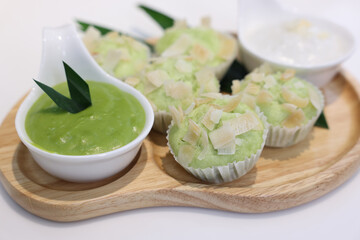 kue mangkok or kue apem or steamed rice cake that look like cup cake and usually sold in a small paper cup.Young coconut pandan cake