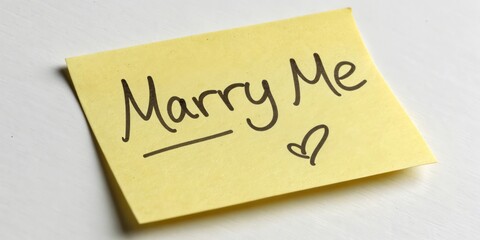 Sticky Note with the Text "Marry Me" and a Heart Symbol on a White Background