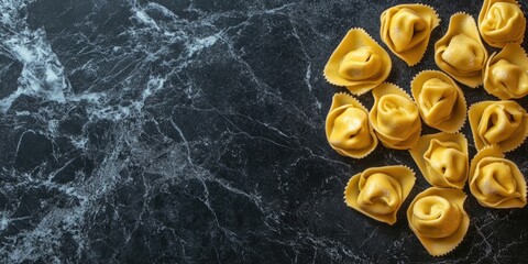 Tortellini pasta arranged on a dark marble surface with ample negative space on the left for text showcasing vibrant yellow and black tones