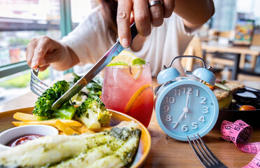 Alarm clock with IF (Intermittent Fasting) 16 and 8 diet rule and weight loss concept.-Diet plan concept