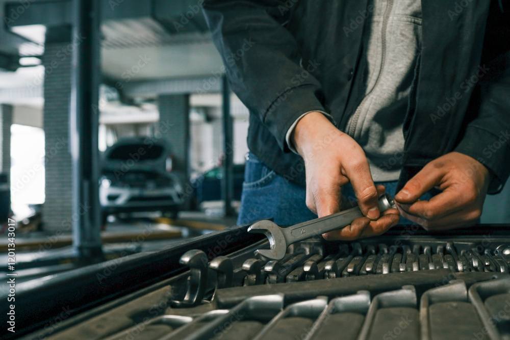 Poster close-up of a mechanic's hand picking wrenches from a well-organized tool tray in a workshop. metal 