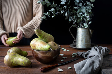 Kitchen wooden table with pears placed on top