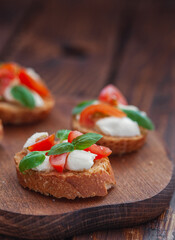 Caprese bruschetta with mini mozzarella cheese, cherry tomato and basil