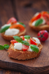 Caprese bruschetta with mini mozzarella cheese, cherry tomato and basil