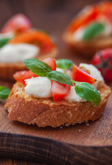 Caprese bruschetta with mini mozzarella cheese, cherry tomato and basil