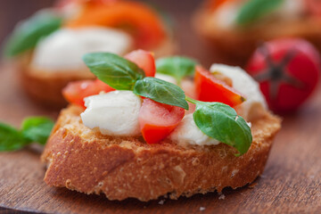 Caprese bruschetta with mini mozzarella cheese, cherry tomato and basil