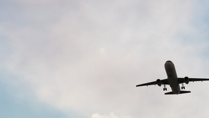 Airplane flies in sky at sunset day. Travel. Airplane Takes Off Against the Background of Sunset. 3840x2160 ULTRA HD.