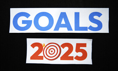 New goals in 2025 concept with mark hitting dartboard on paper, business backdrop. Goals for...