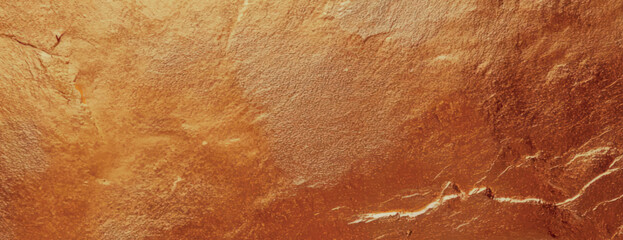 A textured gold background with a metallic sheen. The gold background features a rough, uneven surface, adding depth and richness. Textured stone background vector. Gold background.