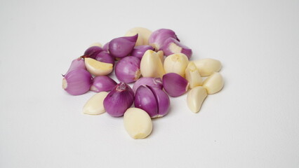 Group of fresh peeled red onions and garlic isolated on white background.