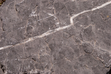 Smooth natural stone with unique light-veined cracks