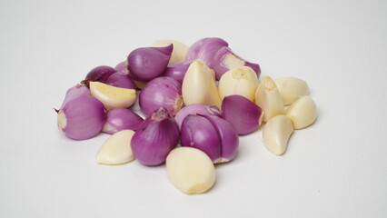 Group of fresh peeled red onions and garlic isolated on white background.