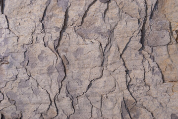 Layered rock with red veins in the Swiss Alps as background