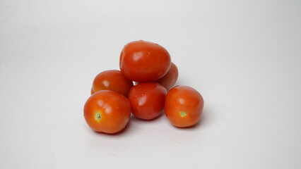 A group of fresh tomatos isolated on white background.