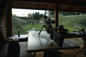 Training shooting weapons at an outdoor shooting range.