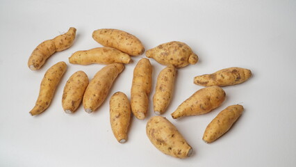 Group of fresh local raw honey sweet potatoes isolated on white background.