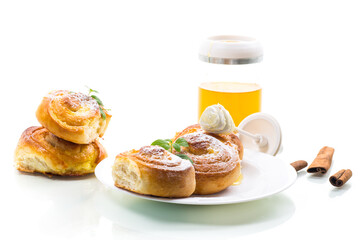 Baked goods. Sweet buns with cottage cheese filling and honey in a plate isolated on a white background