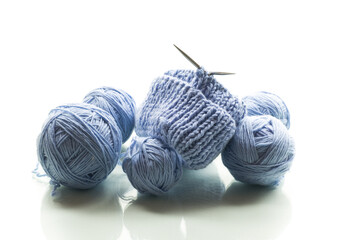Blue yarn with knitting, isolated on white background