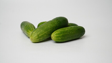 A bunch of fresh cucumbers isolated on a white background.