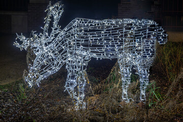 Normandy, France -12- 30- 2024 : Exterior night photo view of christmas light decorations for xmas celebrations decor evening with garlands and tinsel lights,