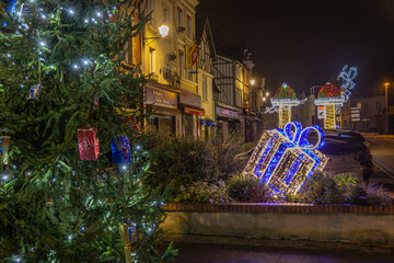 Normandy, France -12- 30- 2024 : Exterior night photo view of christmas light decorations for xmas celebrations decor evening with garlands and tinsel lights,
