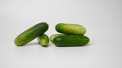 A bunch of fresh cucumbers isolated on a white background.