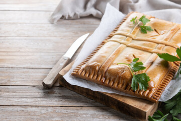 Tuna pie (empanada gallega) on wooden table. Traditional spanish food. Copy space